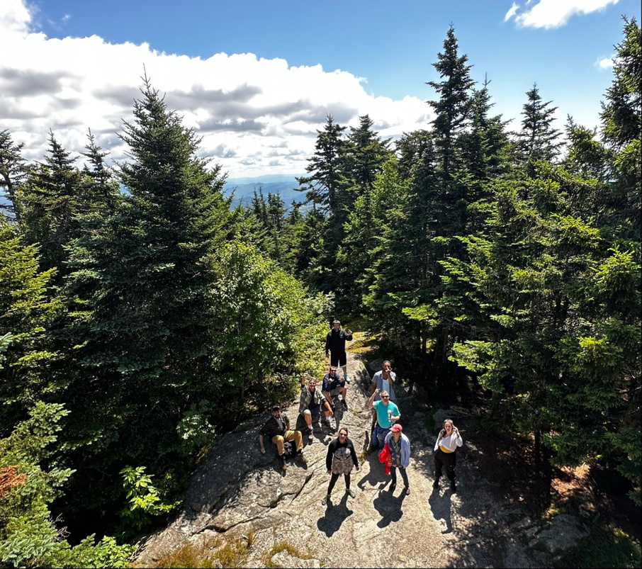 A group on a wooded trail, from Divided Sky’s supplied materials